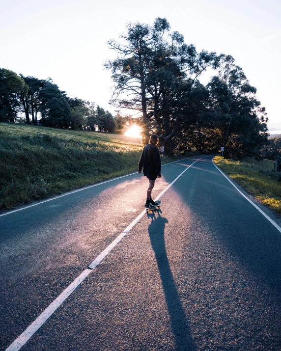 a man rides his skateboard down the street