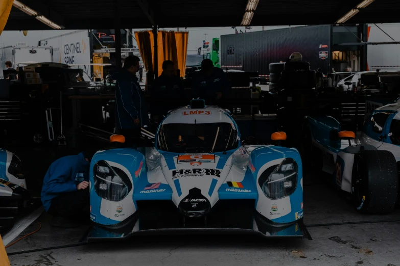 a racing car on display with other racing cars behind it