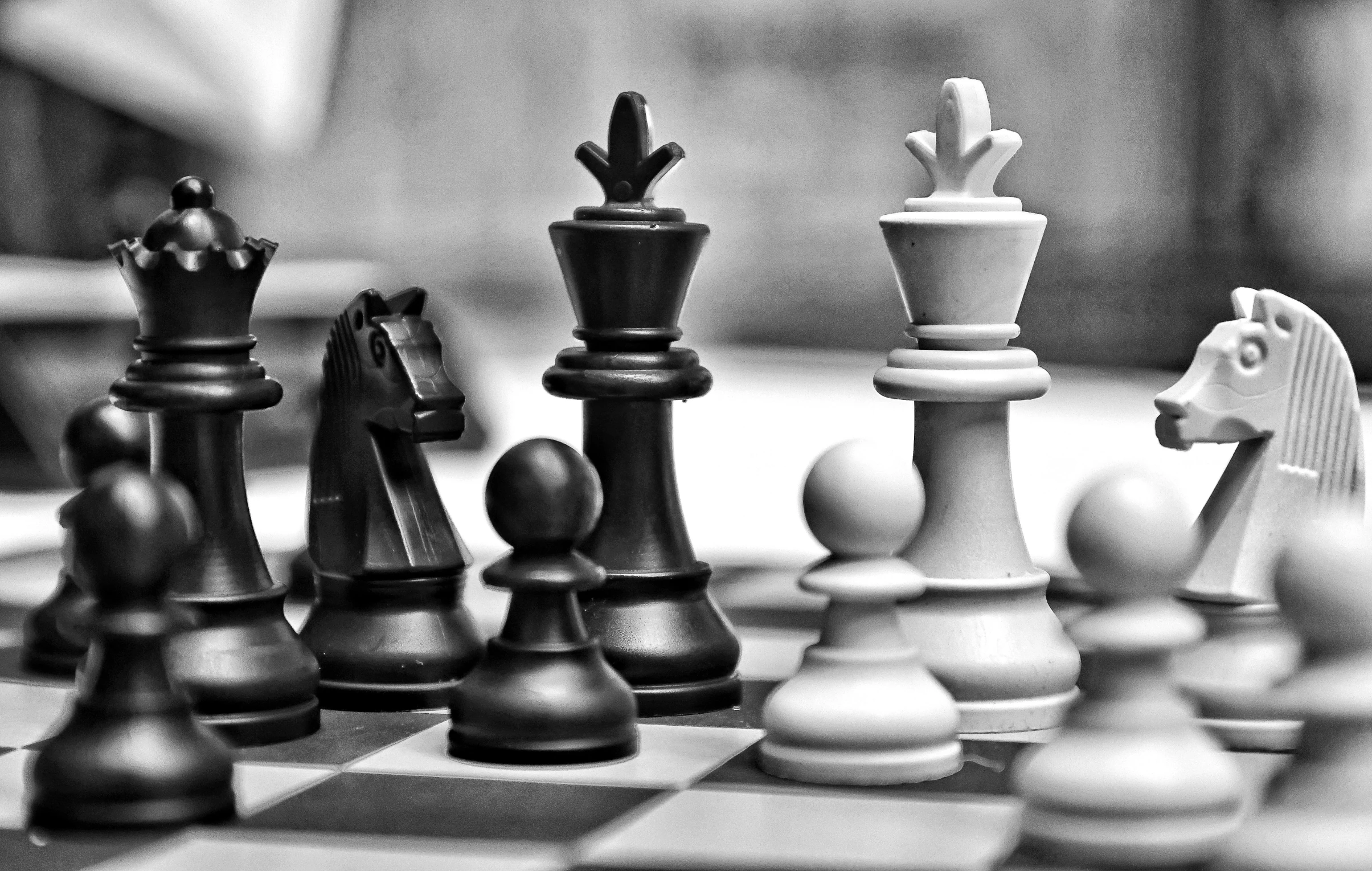 black and white pograph of a chess board with pieces being assembled