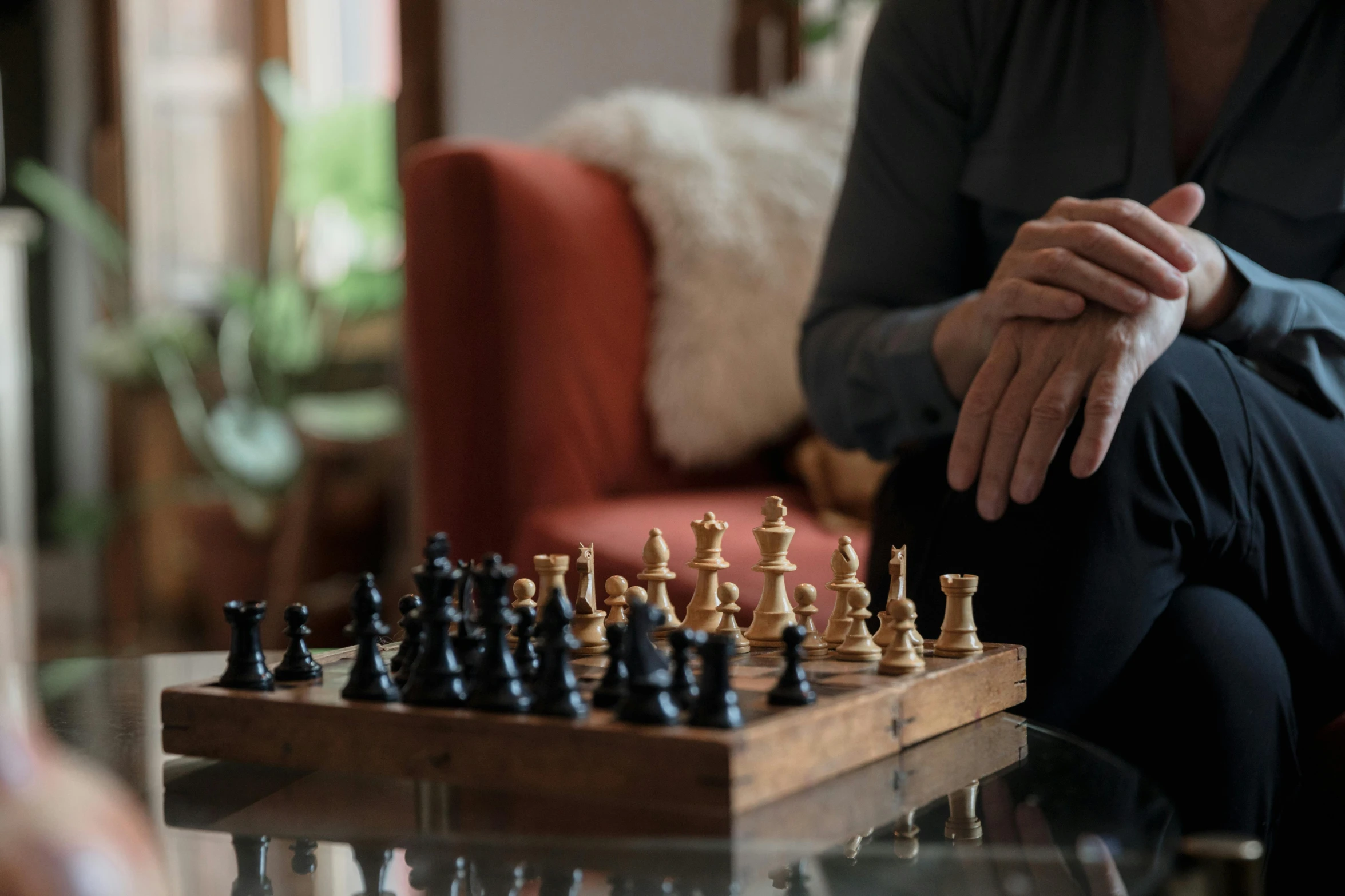 a man sitting on a couch playing chess