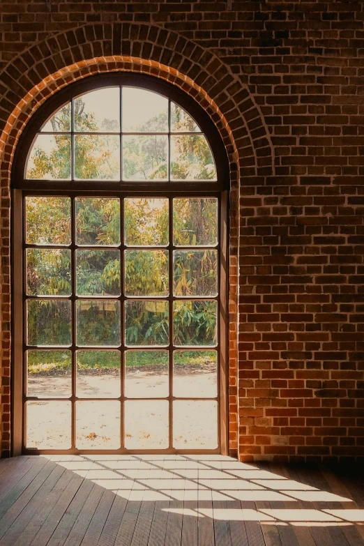 an old brick building has an arched window