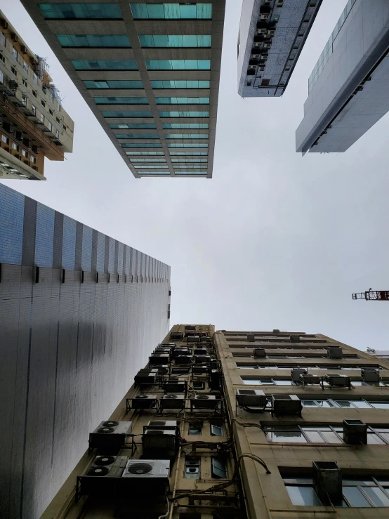 some tall buildings under cloudy skies and light blue sky