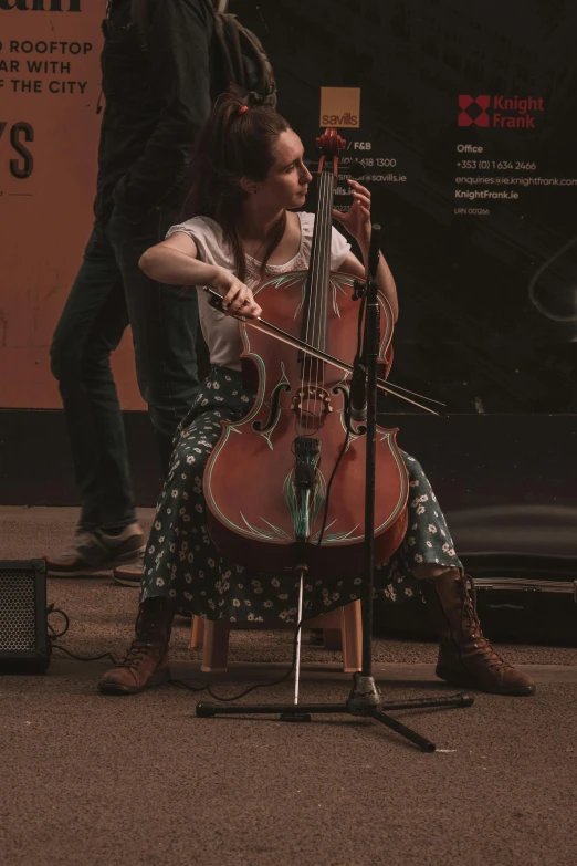 a woman in a dress playing on the street