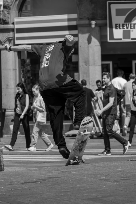 some people are walking on the street and one person is riding a skateboard