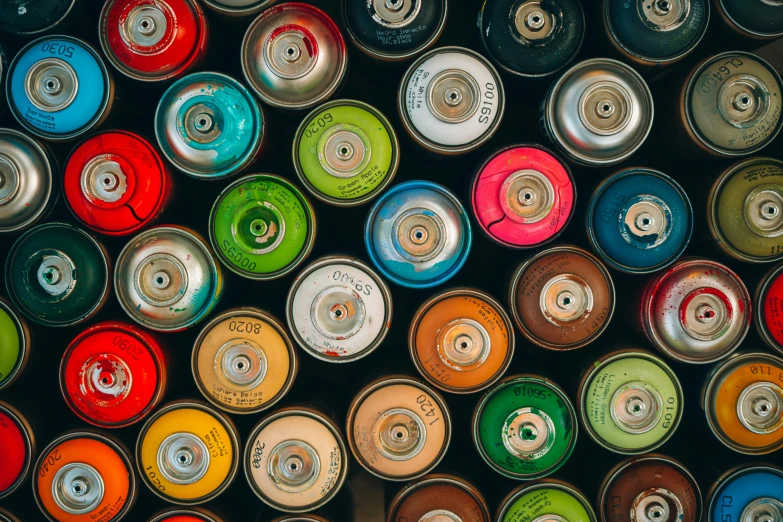 several rows of oil cans, all filled with different colors