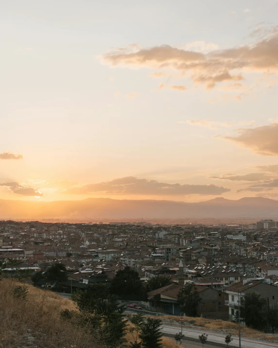 a sunset over a city with lots of buildings