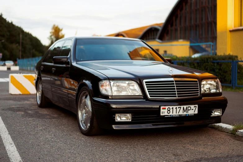 a mercedes benz parked on the side of a road