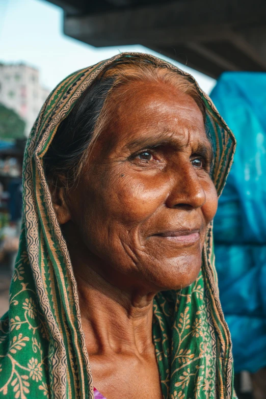 a woman from the ethnic american community wearing green and gold scarf