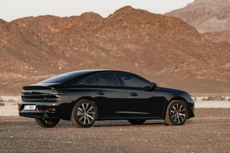 the black sports car is parked in the desert