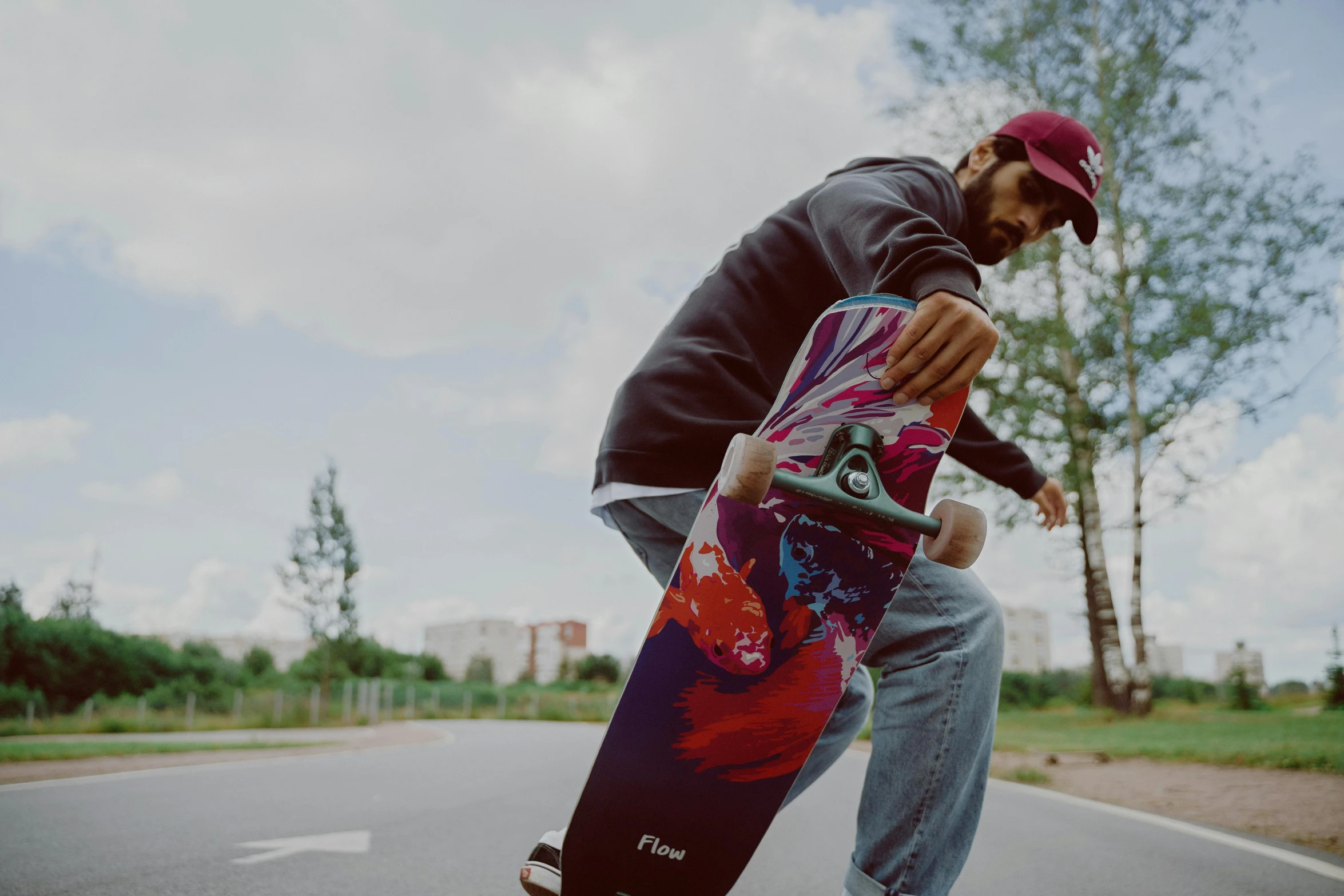 a man riding a skateboard down the side of a road