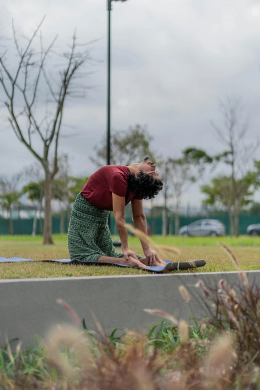 a person in long green pants tying shoes