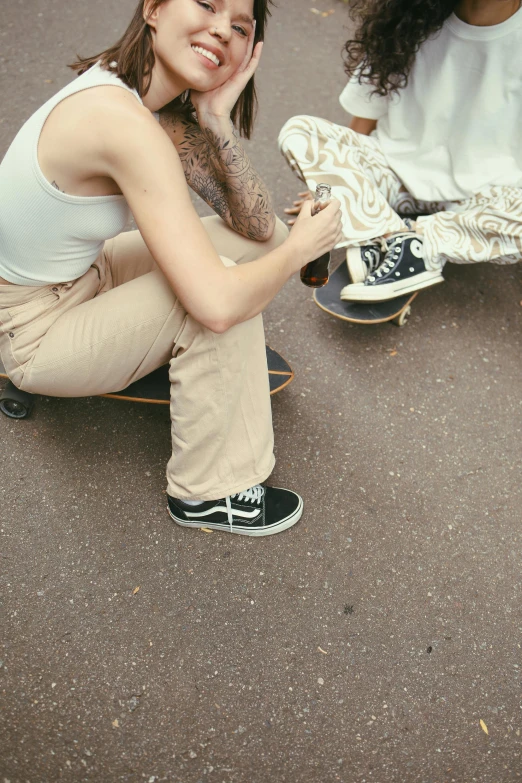 there is a young woman squatting with her skateboard