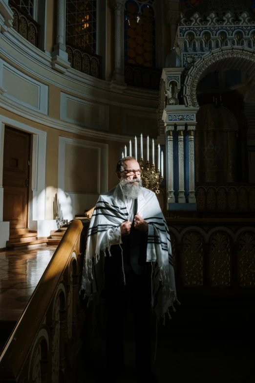 a man that is standing at the top of some stairs