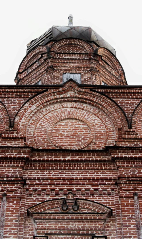 there is a brick building with a clock on top