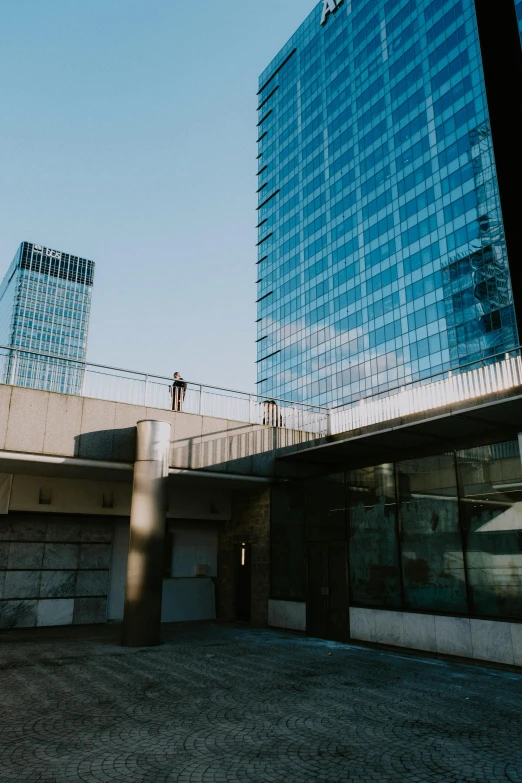 an empty walkway near two tall buildings