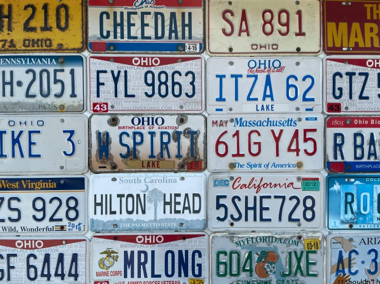 several assorted license plates stacked on top of each other