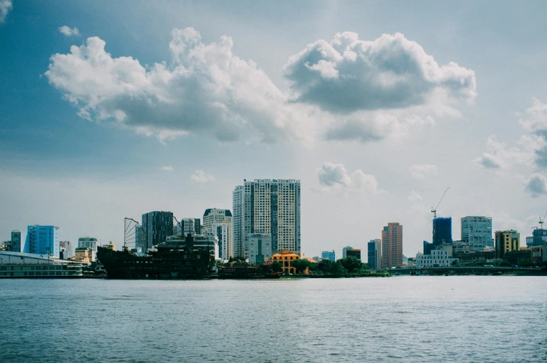 some tall buildings sitting in the middle of a body of water