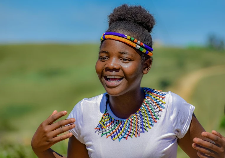 a woman smiles for the camera while wearing colorful beads