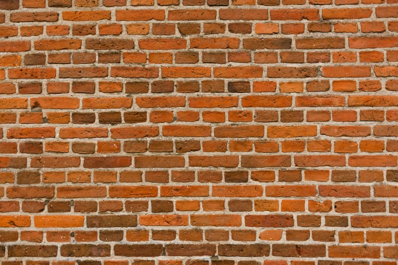 an orange wall made of bricks with only a few small dots