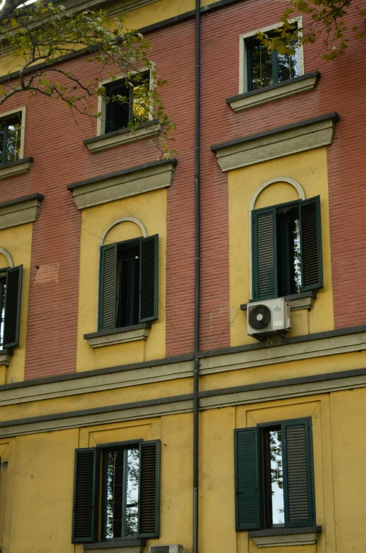 a building with many windows and shutters open