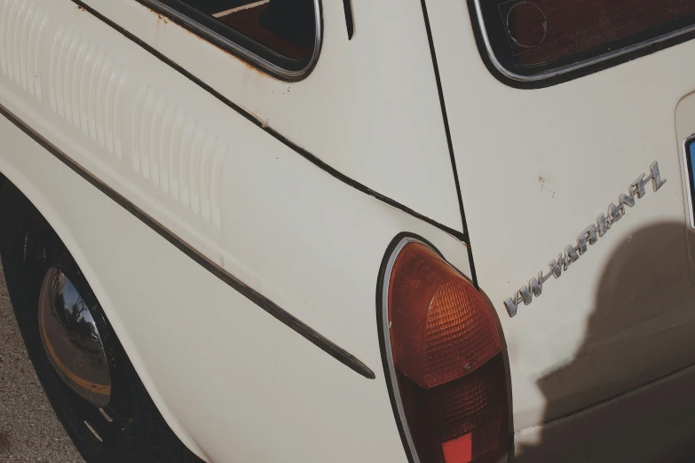 a close up po of a white car with the door handle on