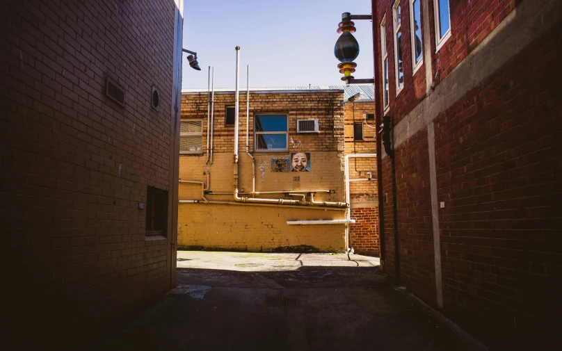 a view of a narrow street between two buildings