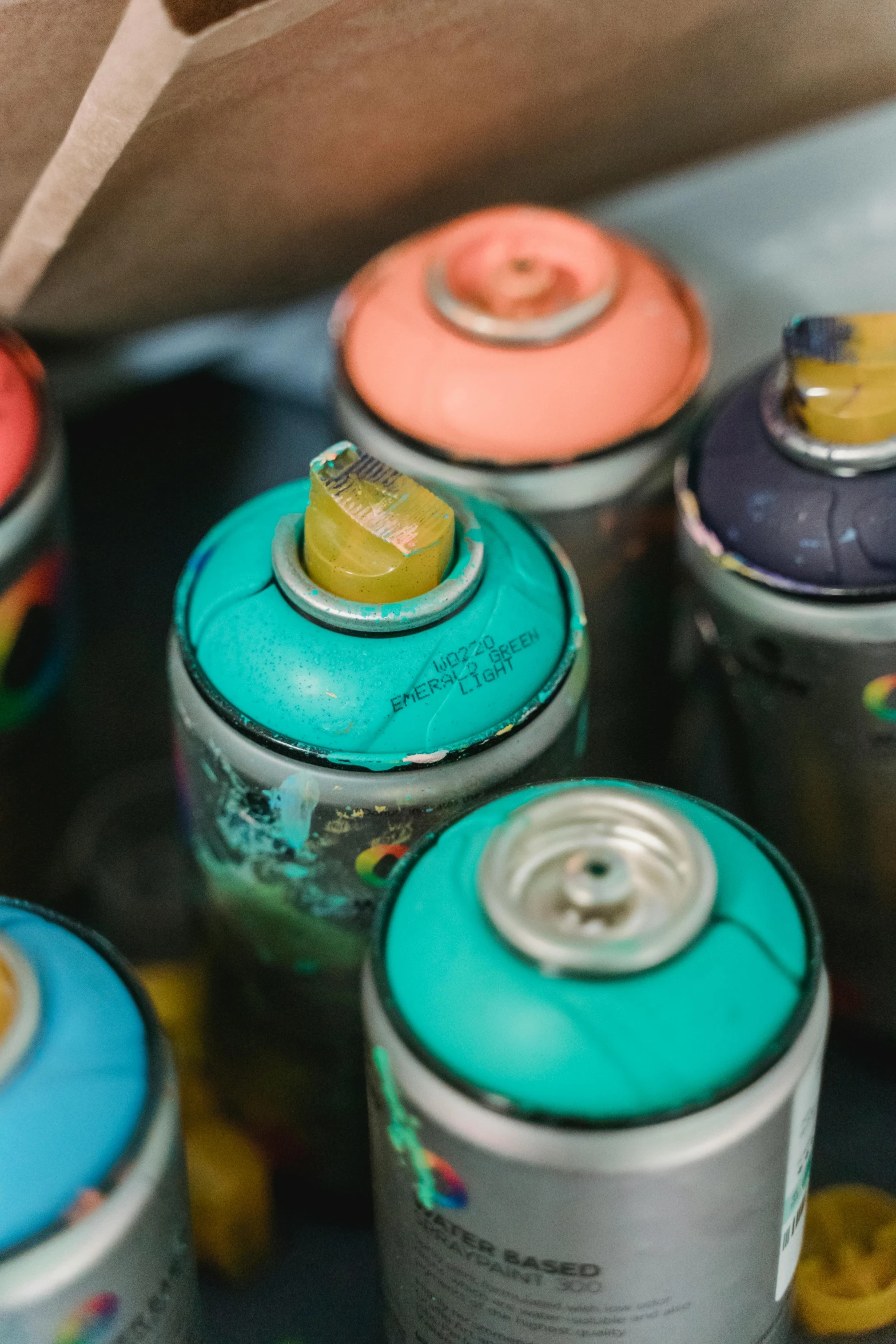 the bottom half of an open canister filled with colored cans