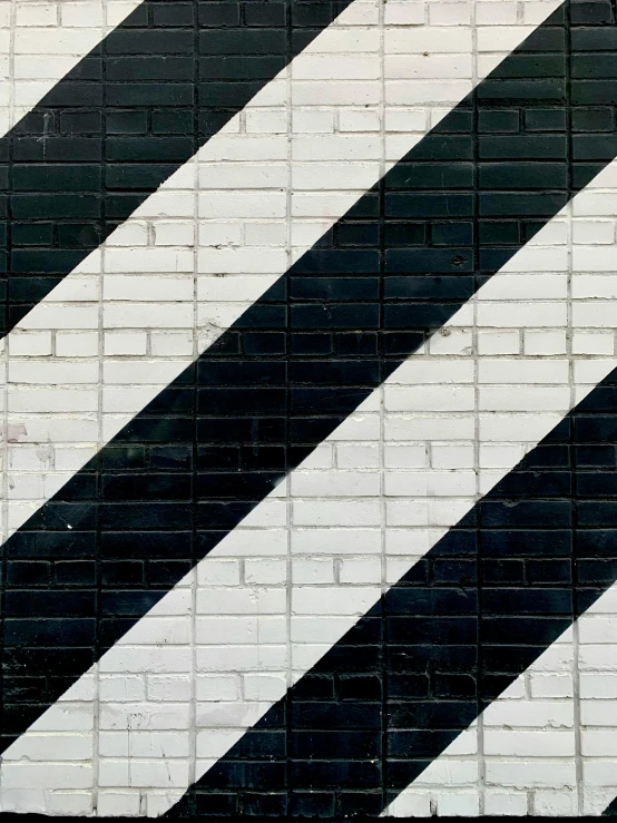 the corner of a building with black and white bricks