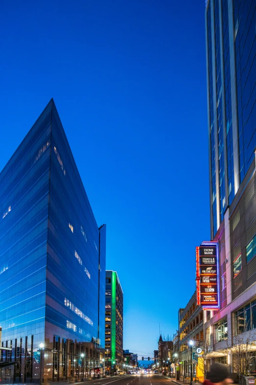 two tall buildings are lit up at night