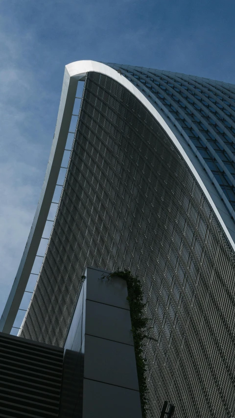 a tall skyscr building is seen against a blue sky