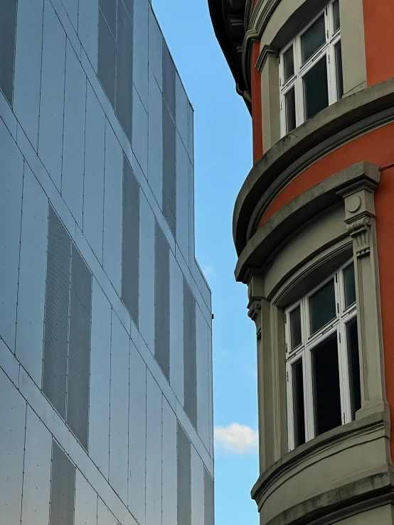 a clock on a pole next to two buildings