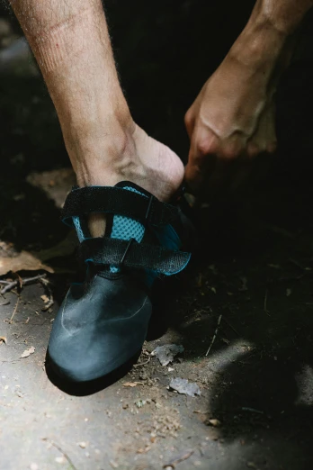 a person's feet in black and blue shoes