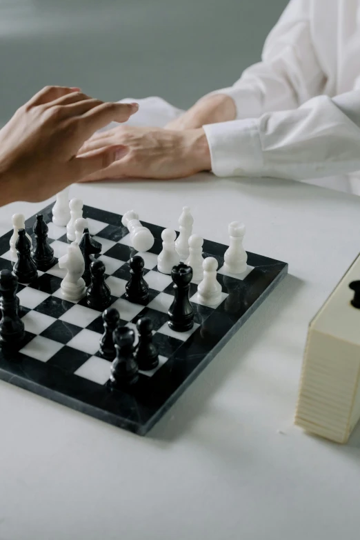 a man sitting at a table playing chess