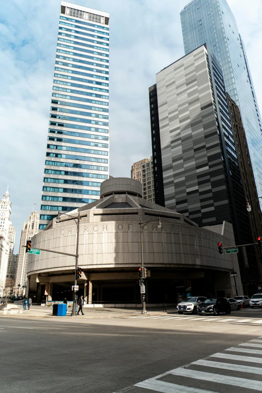 a city street corner with tall buildings in the background