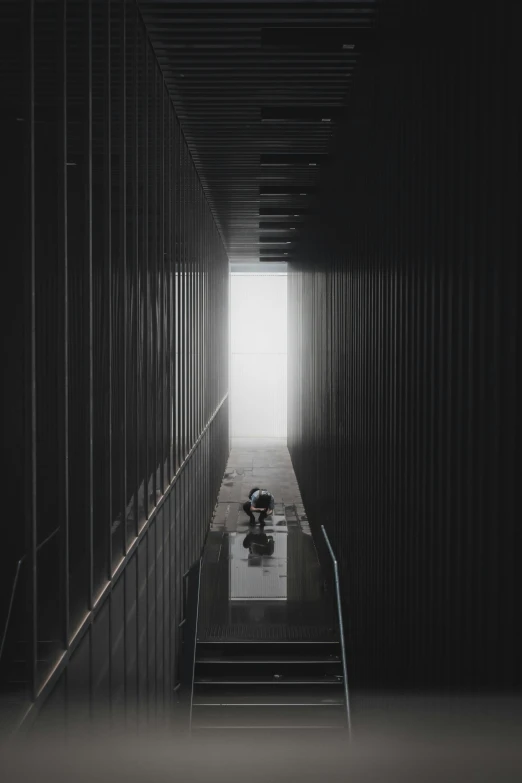 an empty hallway with two people walking down the middle