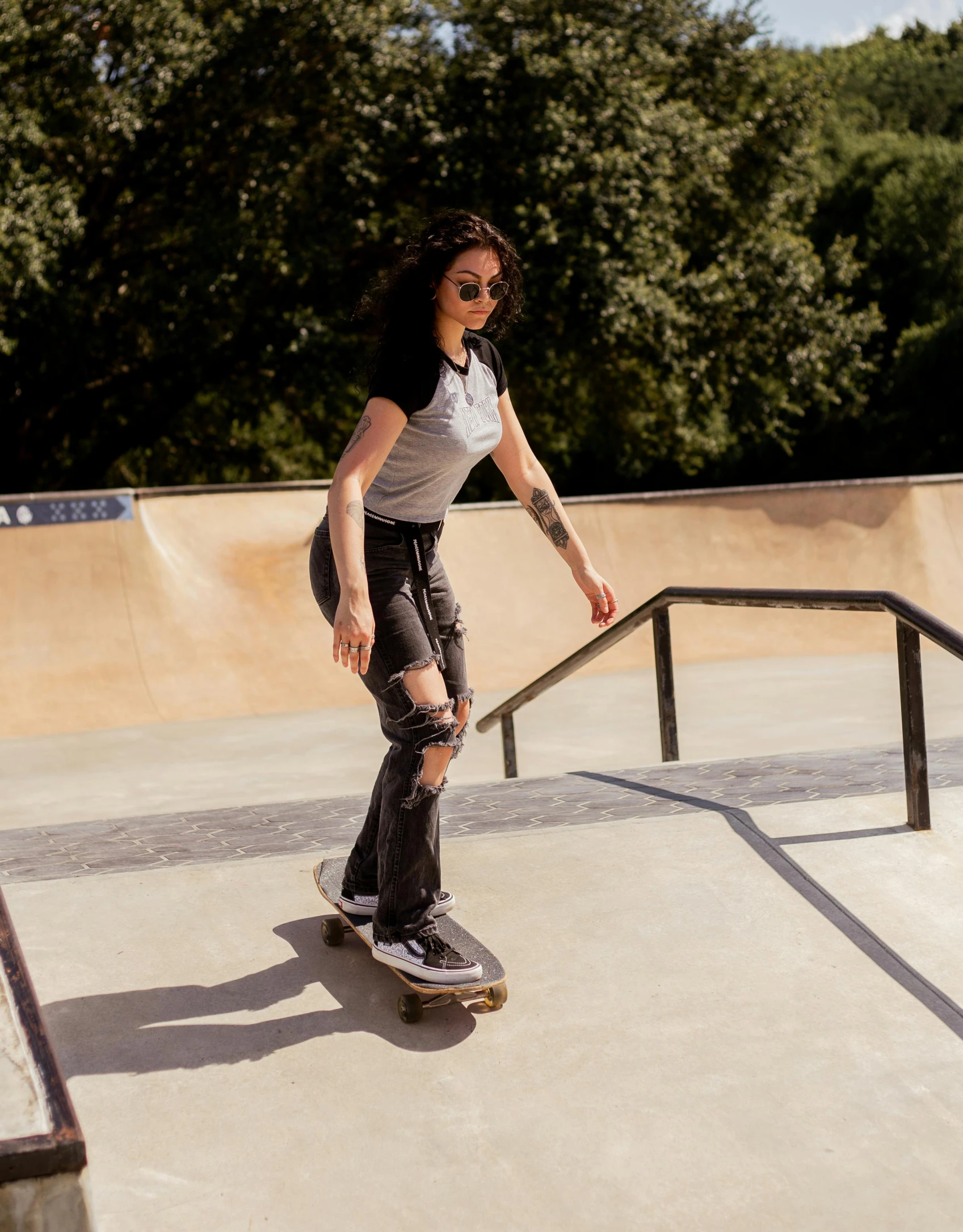 a girl is standing on her skateboard in the park