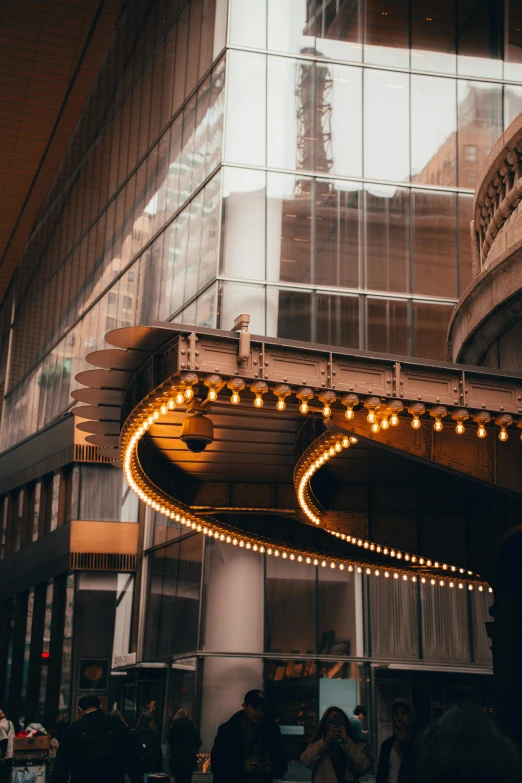 the entrance to a theater building with a large lighted sign in the front