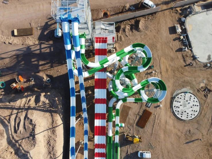 a carnival set up with a giant green and red striped slide