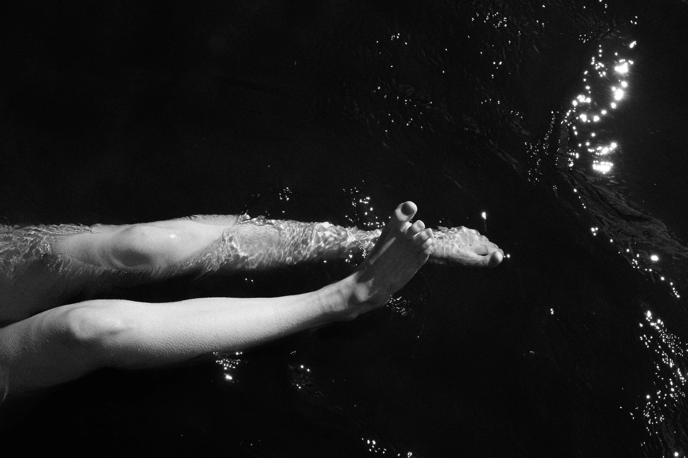 a person's feet with water in the background