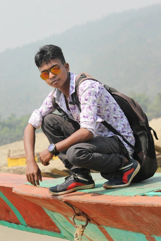 a man sitting on the edge of a skateboard ramp