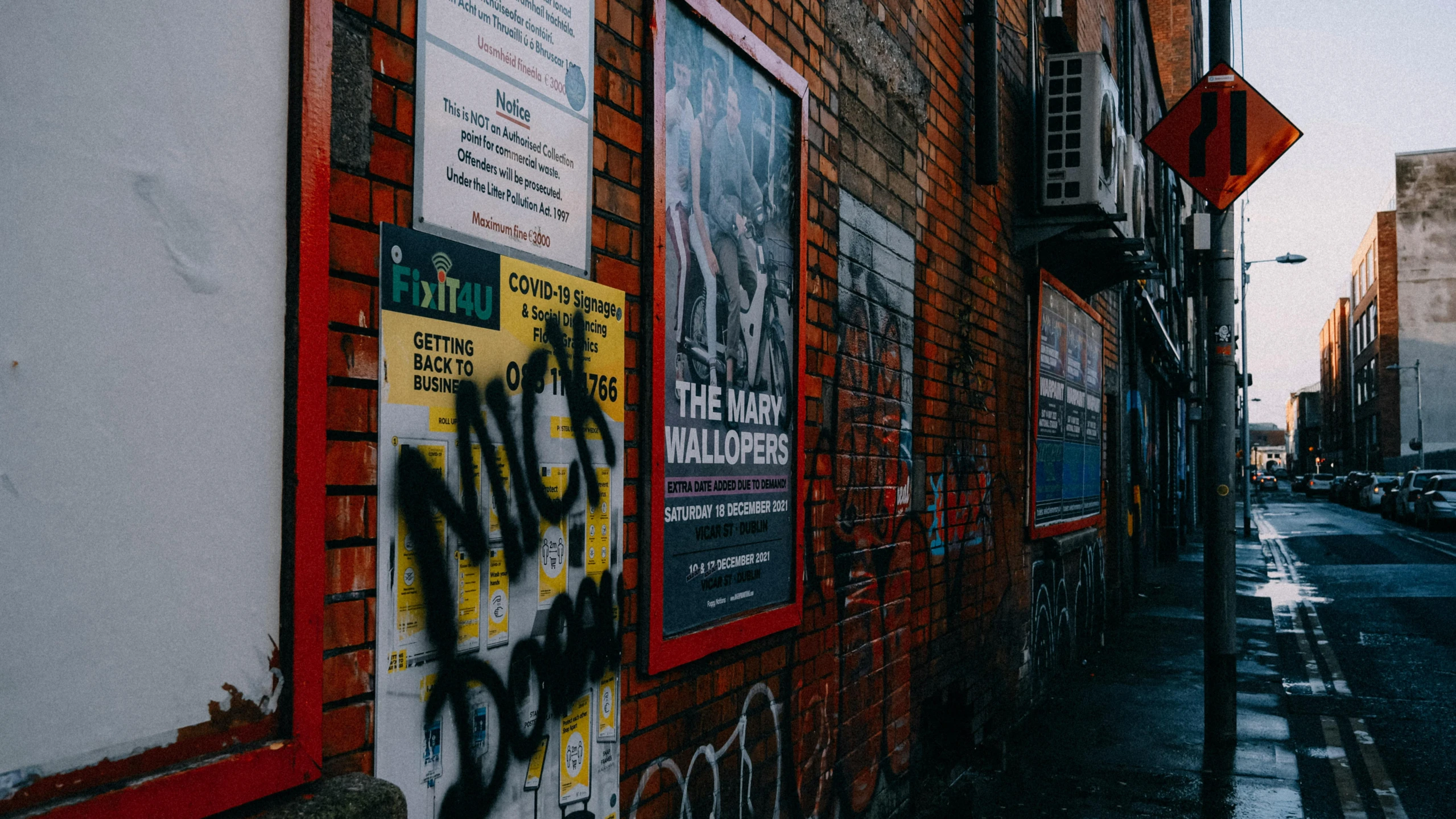 graffiti on the side of a building with buildings behind