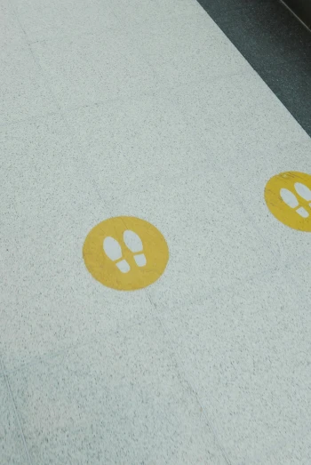two yellow circular circles that are painted on a concrete surface