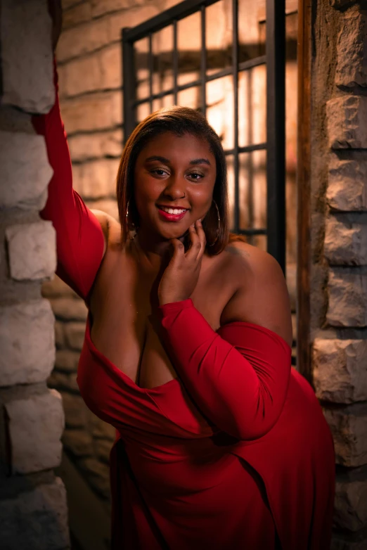 a smiling woman in a red dress poses for the camera