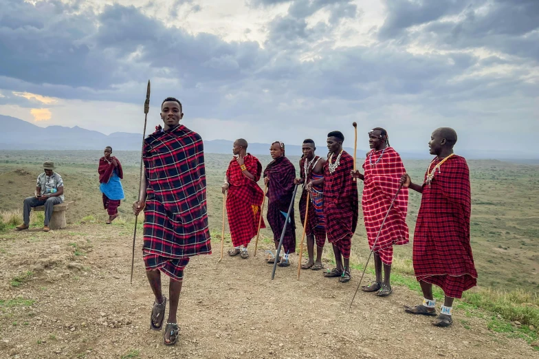 the men are walking with the long sticks