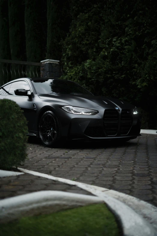 a black sports car parked in front of a house