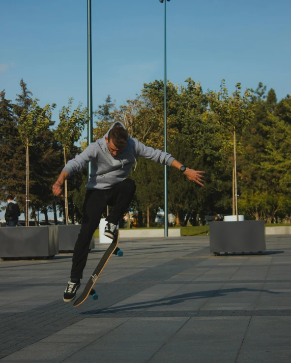 a skateboarder is doing a trick in an empty lot