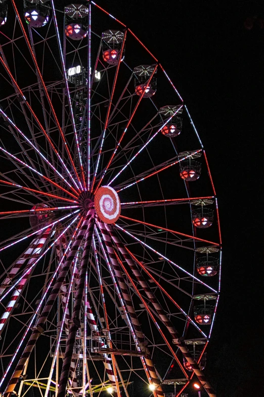 a ferris wheel is lit up at night