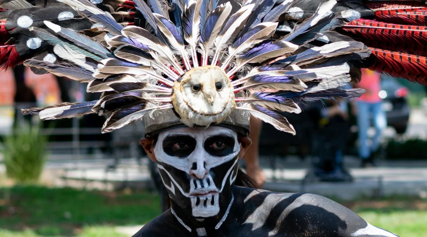 man in black with white and red headdress