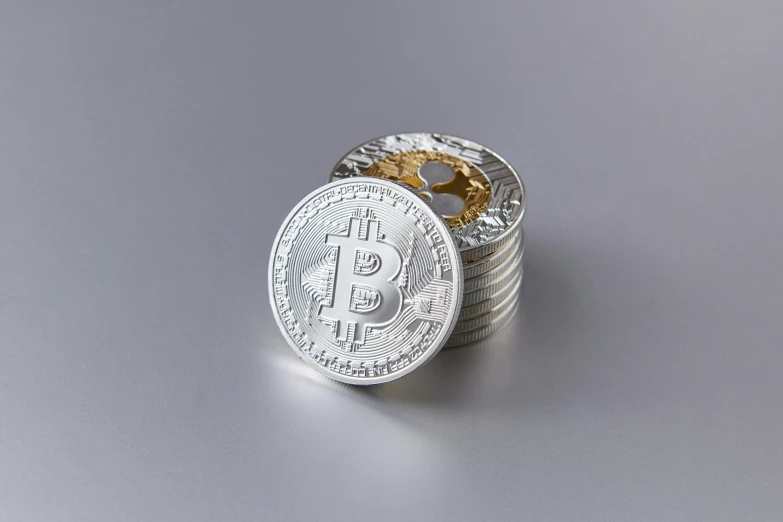 stacked coin coins stacked on each other and with a bitcoin
