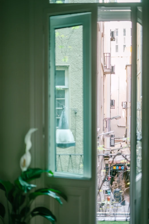 an open door to a balcony with a city view